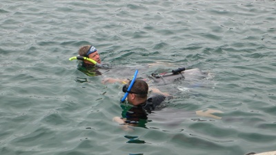 Divers tow an AUV back to the starting gate